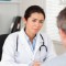 Pretty female doctor listening carefully to a patient